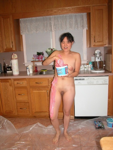 Asian babe Colette covers her naked body with cream in a kinky food play solo