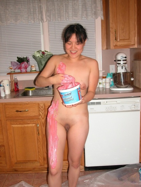Asian babe Colette covers her naked body with cream in a kinky food play solo